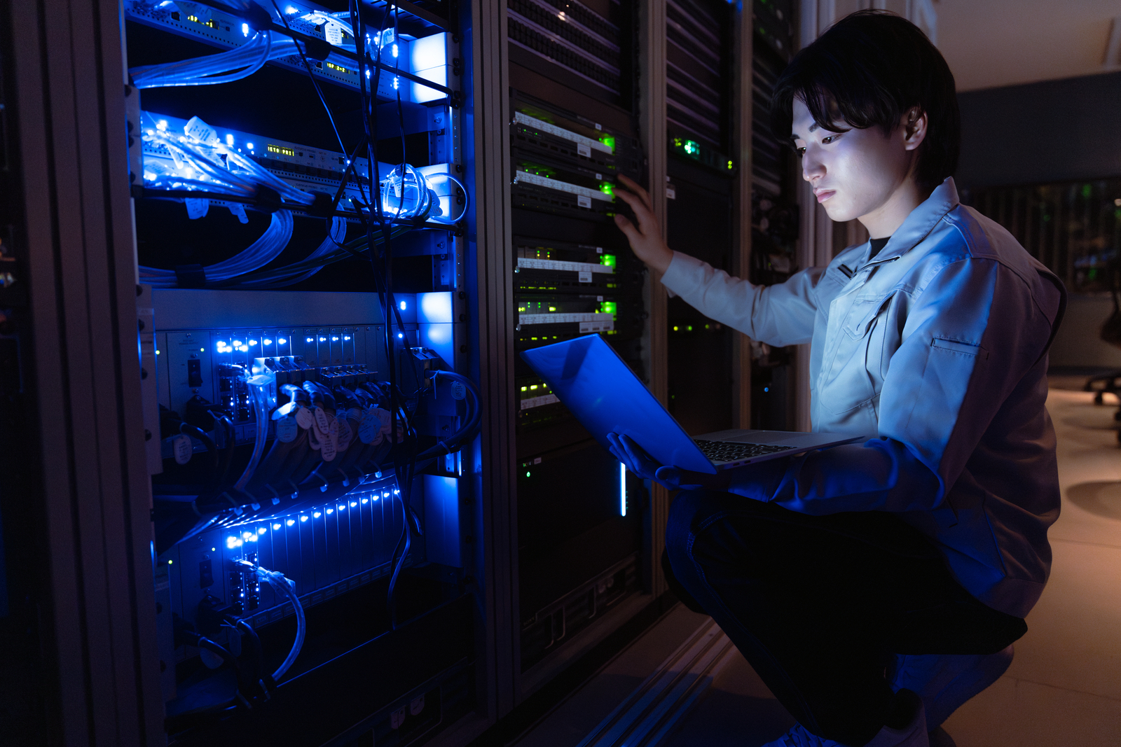 a woman system administrator in datcenter interacting with storage systems