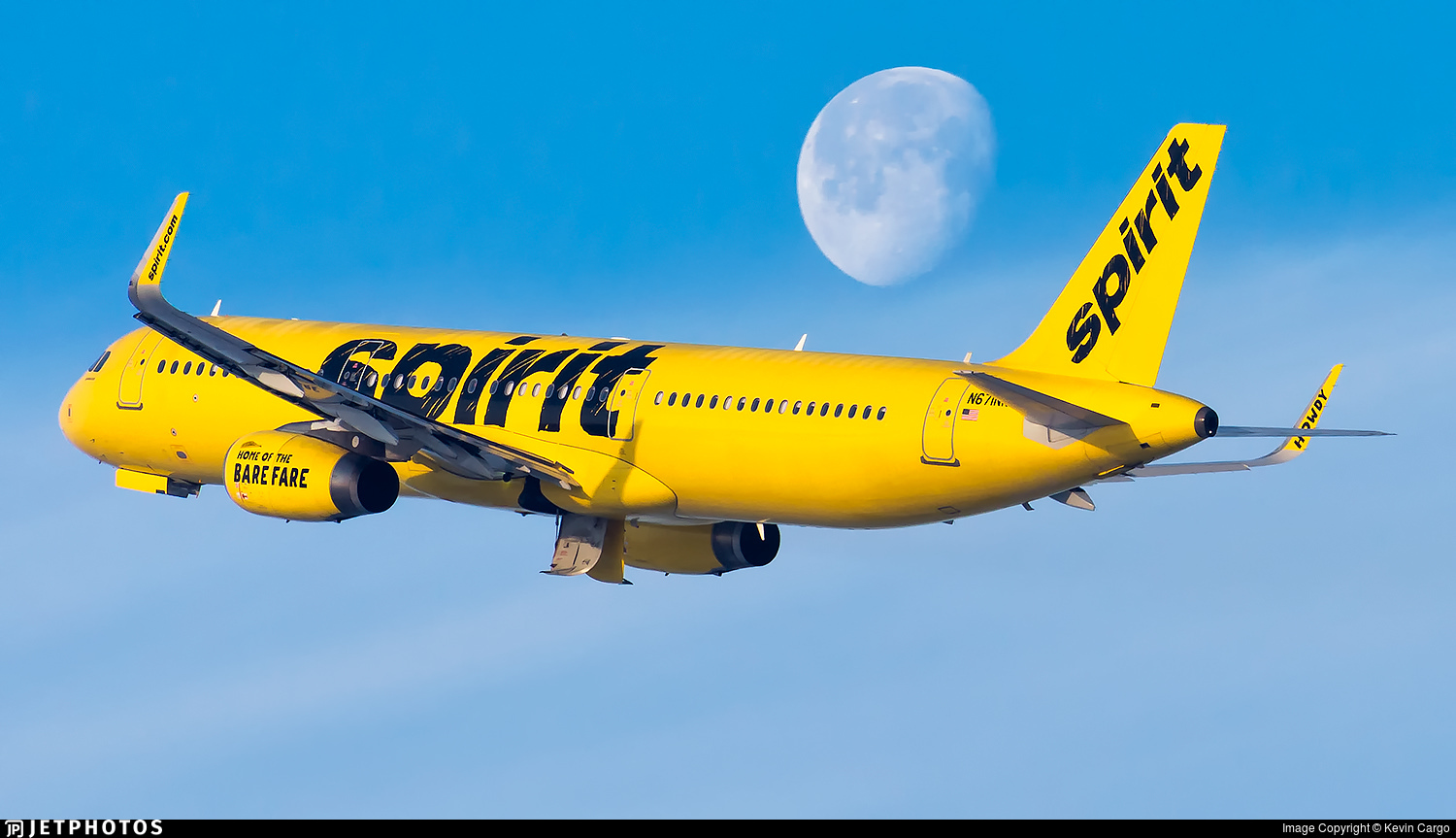 A Spirit Airlines A321 flying past the moon