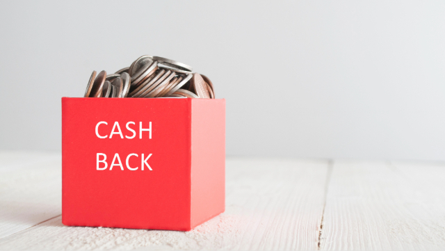 White background, red box sitting on white plank flooring. The red box says Cash Back on it and it is full of coins. 