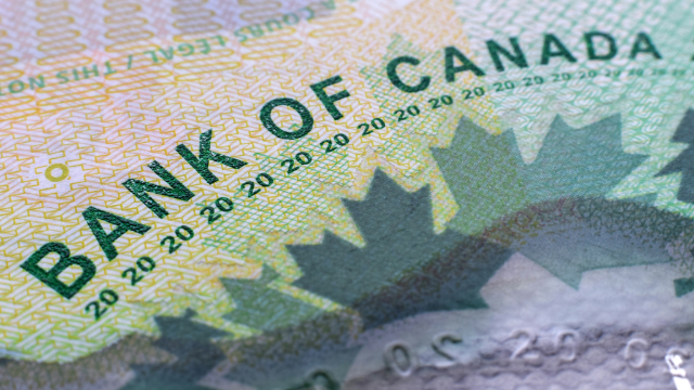 Close up of a $20 CAD bill and the words Bank of Canada on it. 