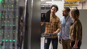 Three people viewing a screen observing computer room stats