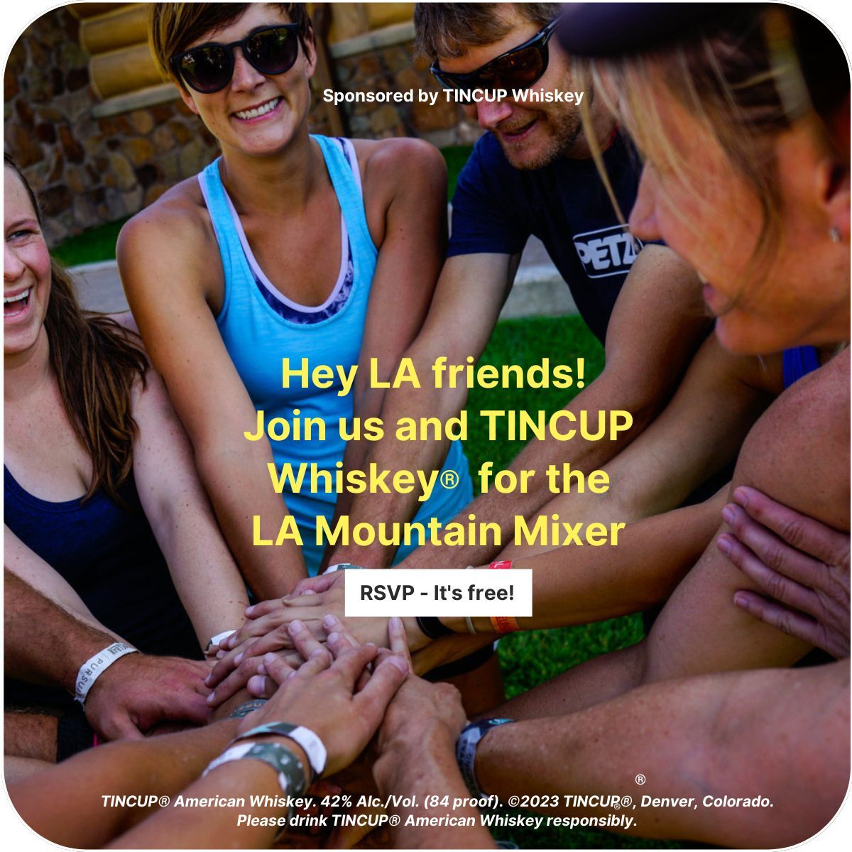 A group of people have their hands in a pile as if to to a cheer.